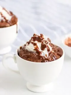 low-carb chocolate mug cake with glaze and whipped topping