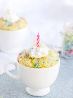 keto birthday cake in a mug with a candle