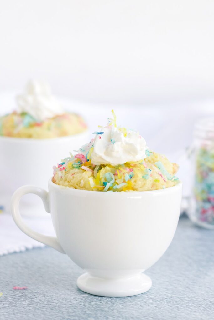 vanilla funfetti cake with whipped cream in a mug