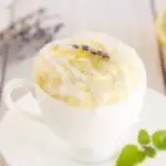yellow cake in a white mug with lavender on the table
