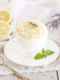 lemon cake in a mug with lemons and lavender around on the table