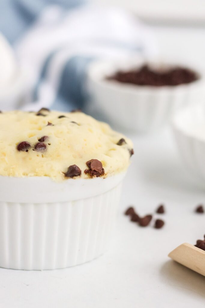 Chocolate chip mug cake in a ramekin with chips around