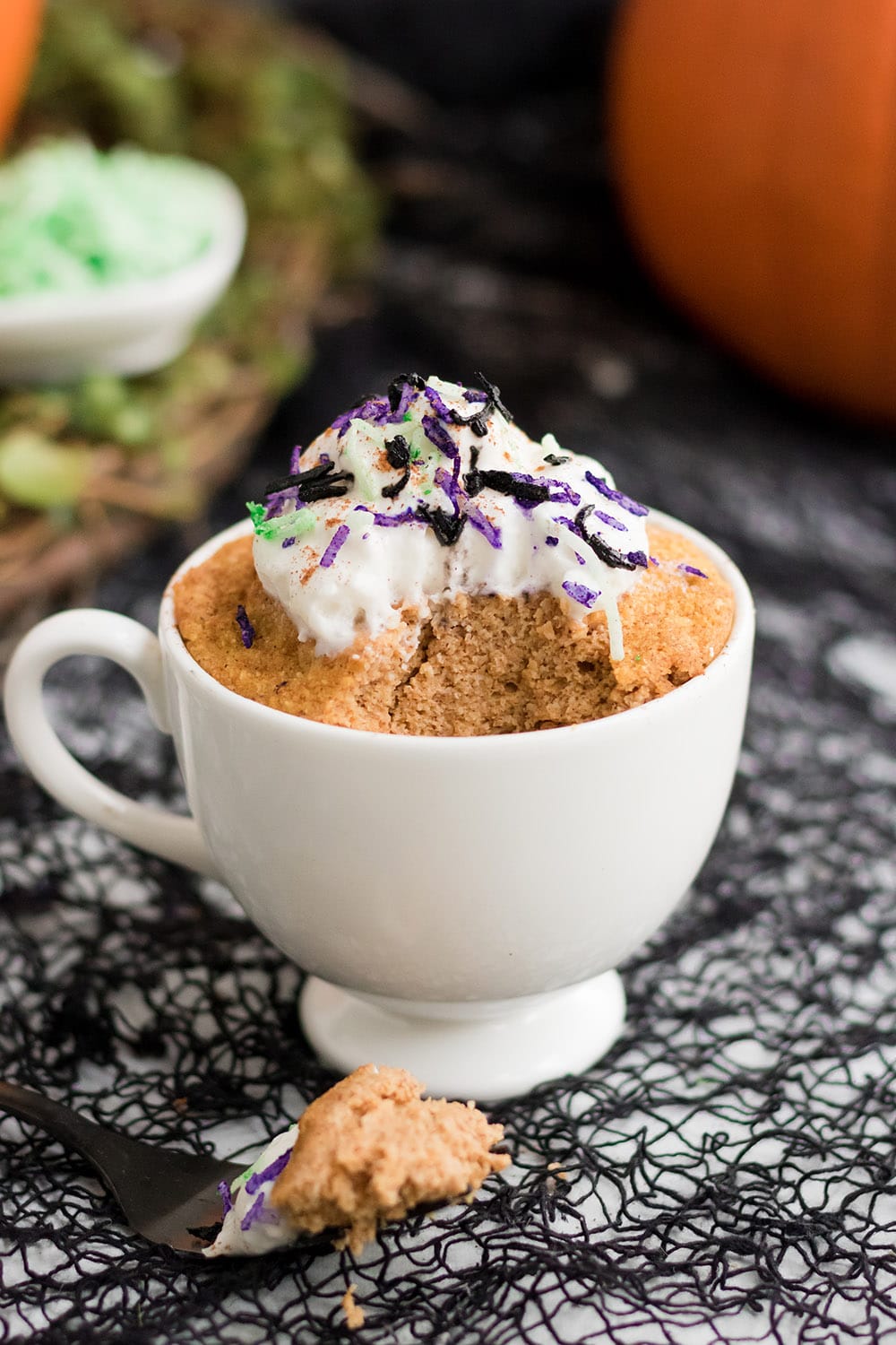 Halloween mug cake with a bite taken out of it.