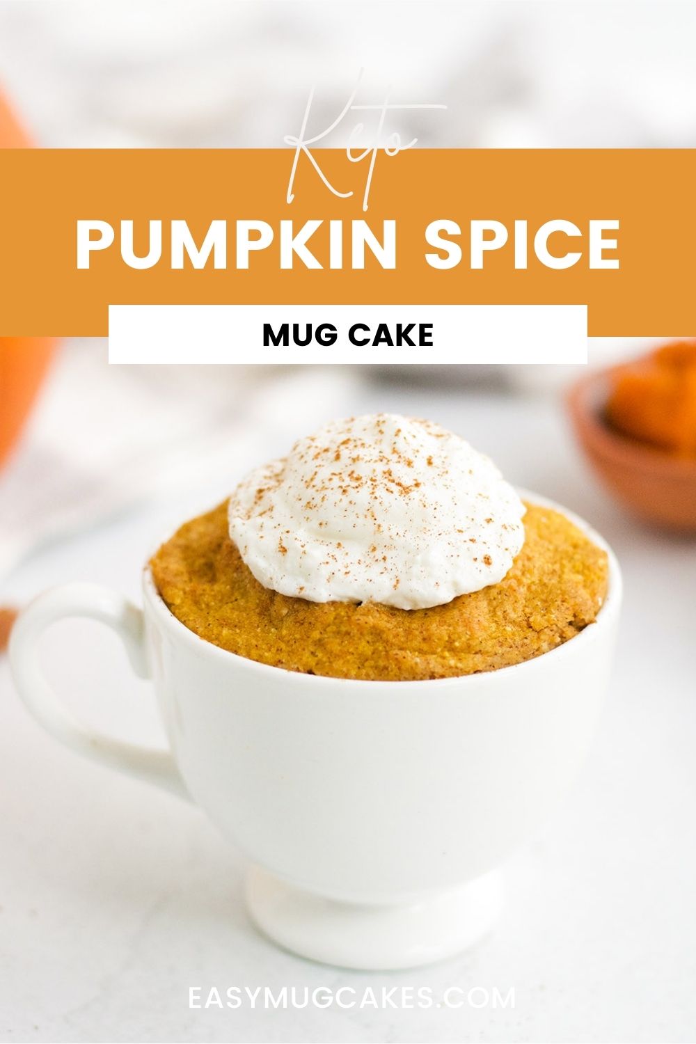 Keto pumpkin spice cake in a mug with whipped cream.