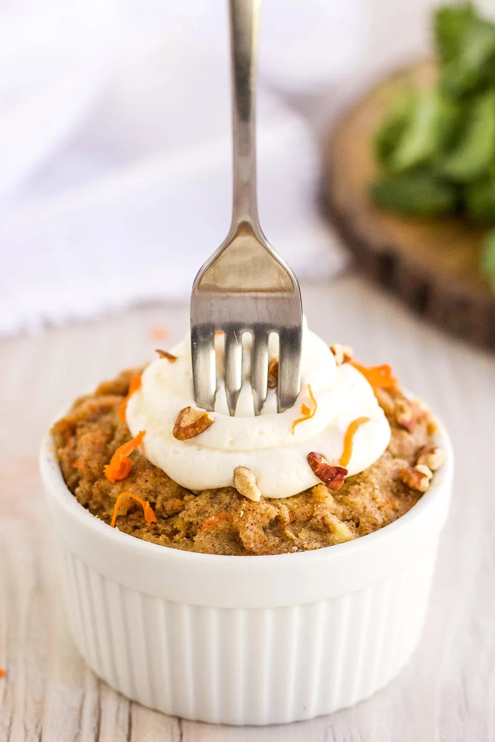 Fork stuck in a low-carb carrot mug cake.