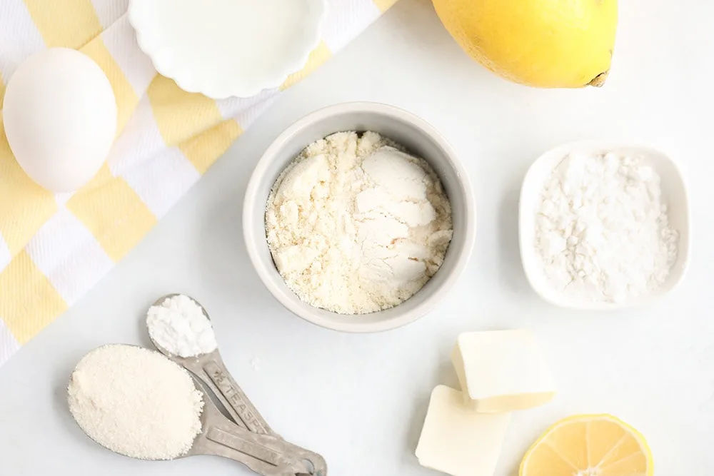 Flour, egg, butter, lemon, and other ingredients for lemon cake. 