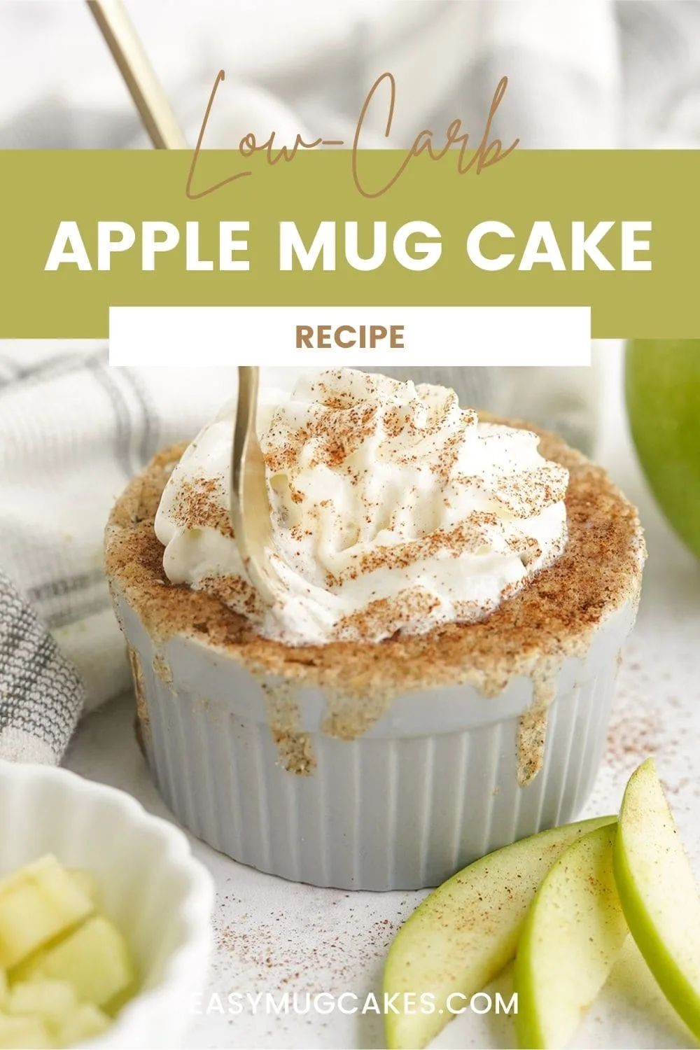 Apple mug cake topped with whipped cream and cinnamon.