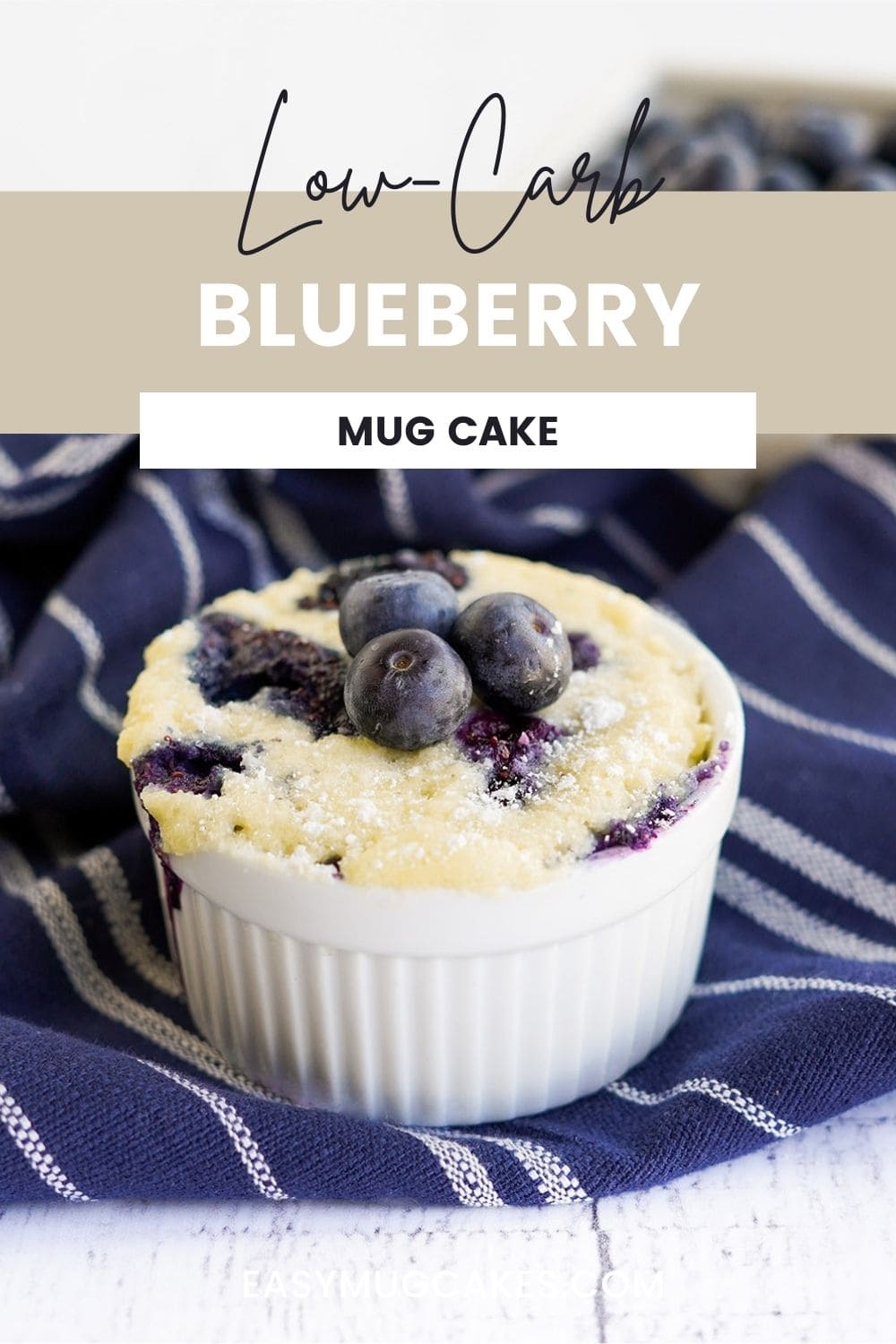 Blueberry mug cake in a white ramekin on a blue napkin.