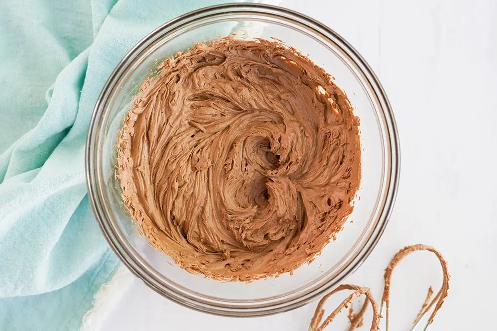 Clear mixing bowl full of whipped chocolate topping.