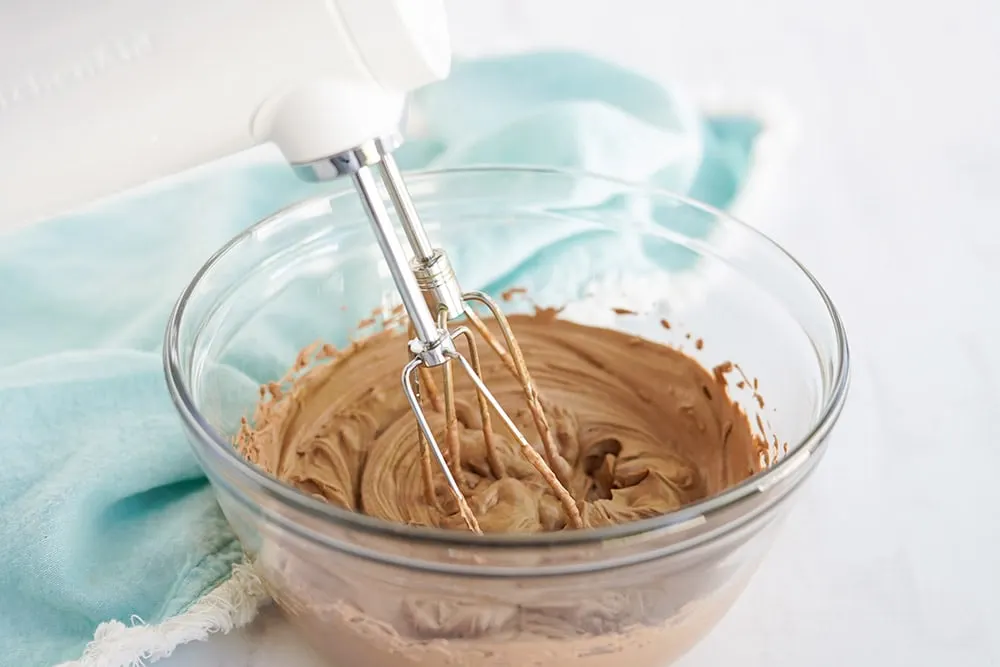 Mixing chocolate whipped cream in a bowl.