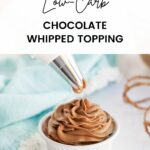Piping chocolate whipped cream into a white dish.
