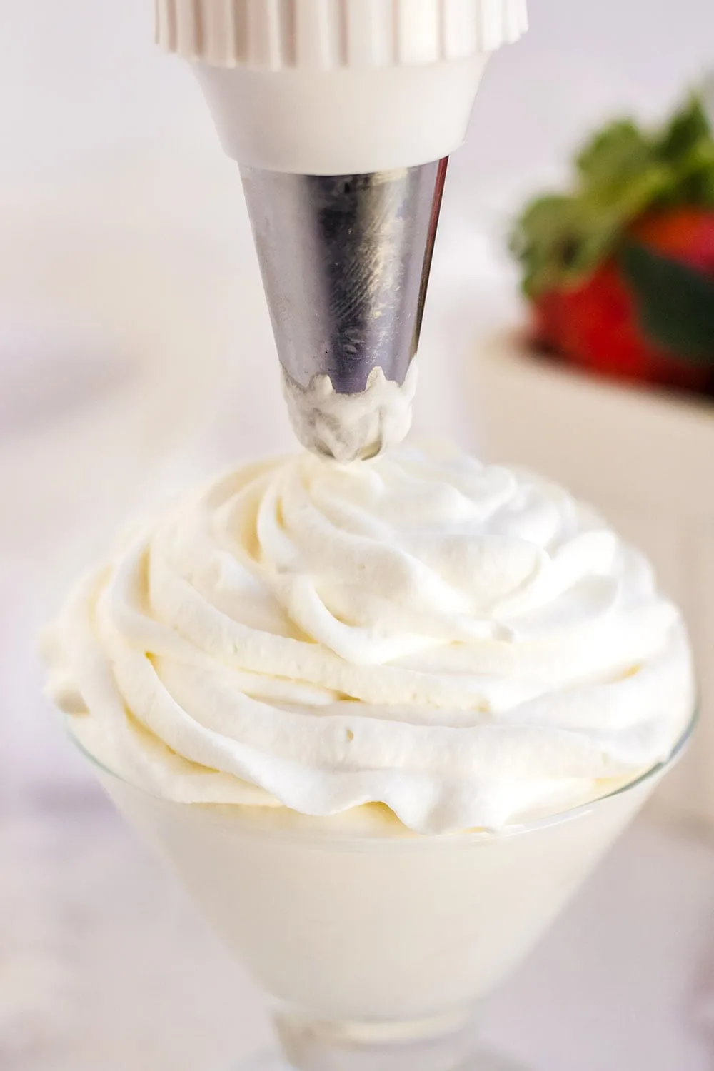 Piping whipped topping into a glass.